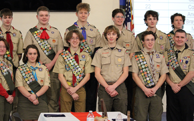 Twelve male and female members of the Eagle Scout class of 2023 at their recognition dinner in full uniform